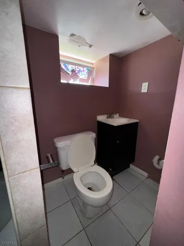 a white toilet sitting next to a sink