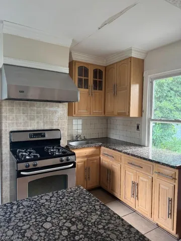 a kitchen with a sink a stove a microwave and cabinets