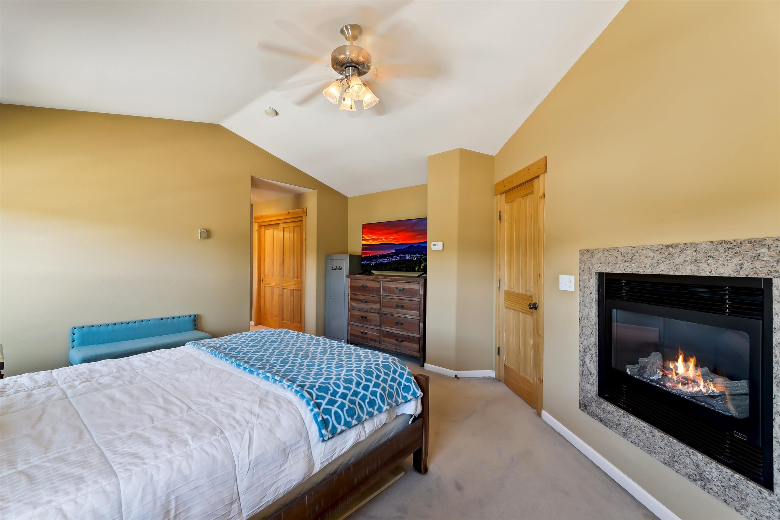 10096 Nicolas Drive, Unit C Truckee, CA 96161 - Photo 14 of 22 a bedroom with a bed and a fireplace