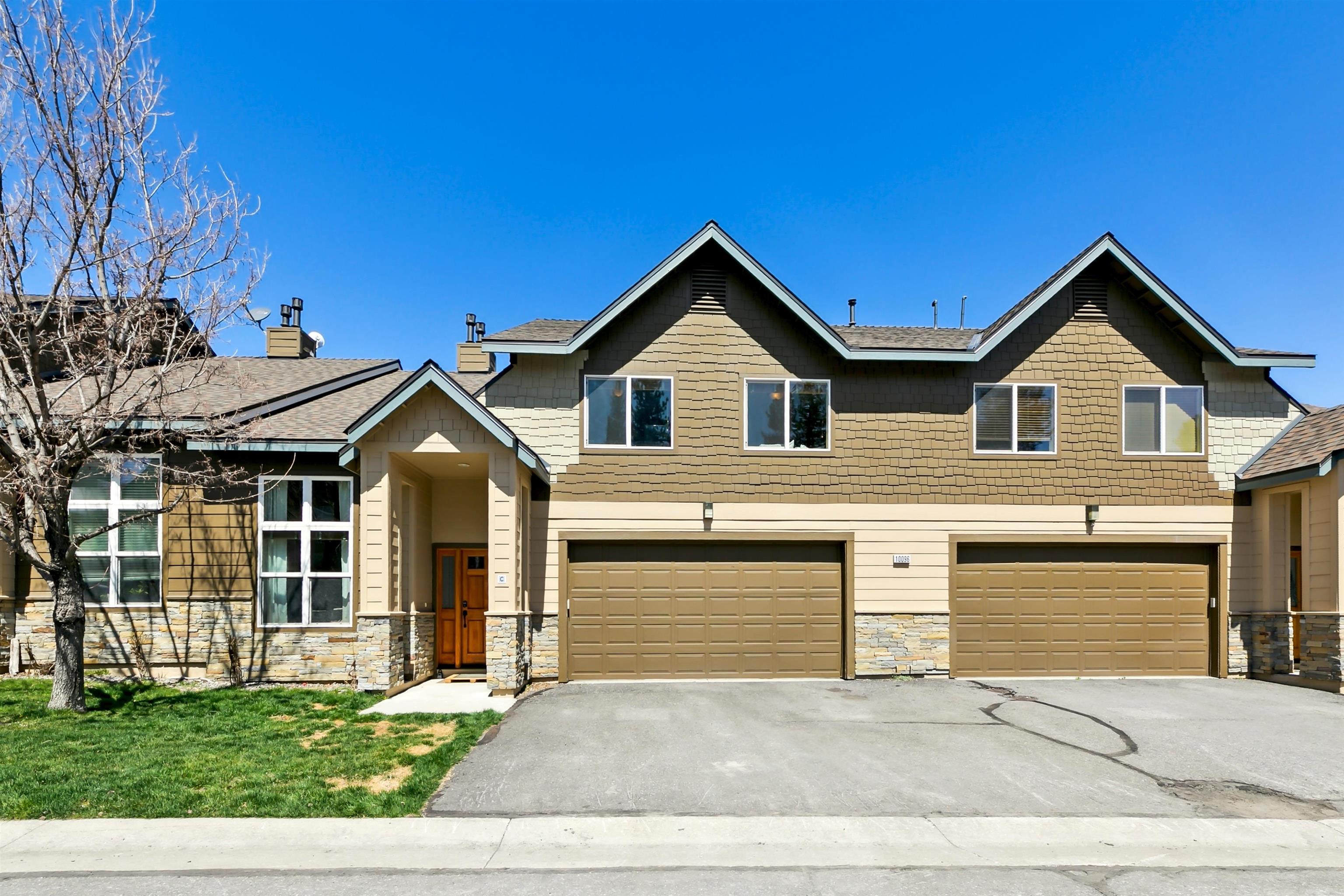 10096 Nicolas Drive, Unit C Truckee, CA 96161 - Photo 2 of 22 a front view of a house with a yard and garage