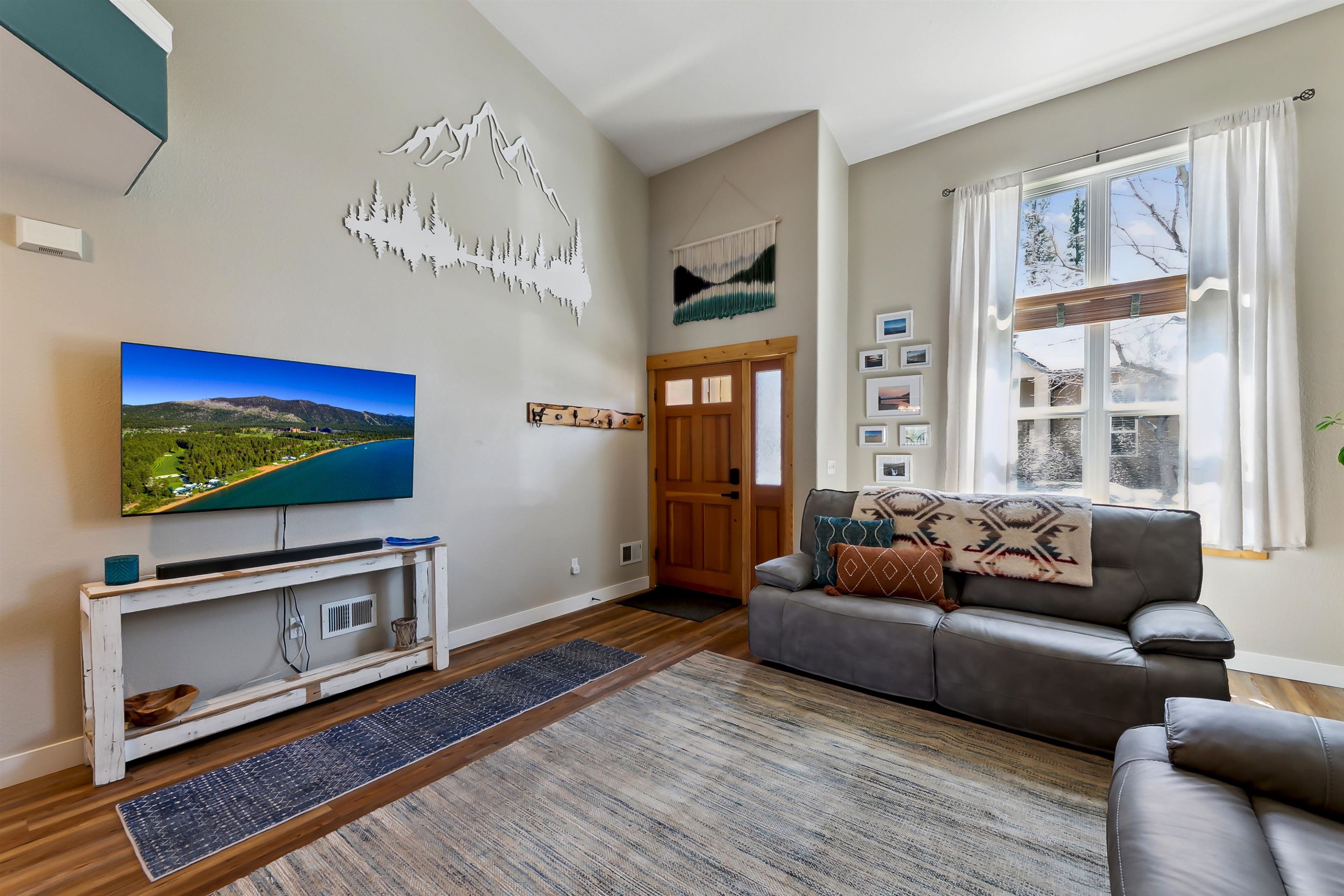 10096 Nicolas Drive, Unit C Truckee, CA 96161 - Photo 5 of 22 a living room with furniture flat screen tv and wooden floor