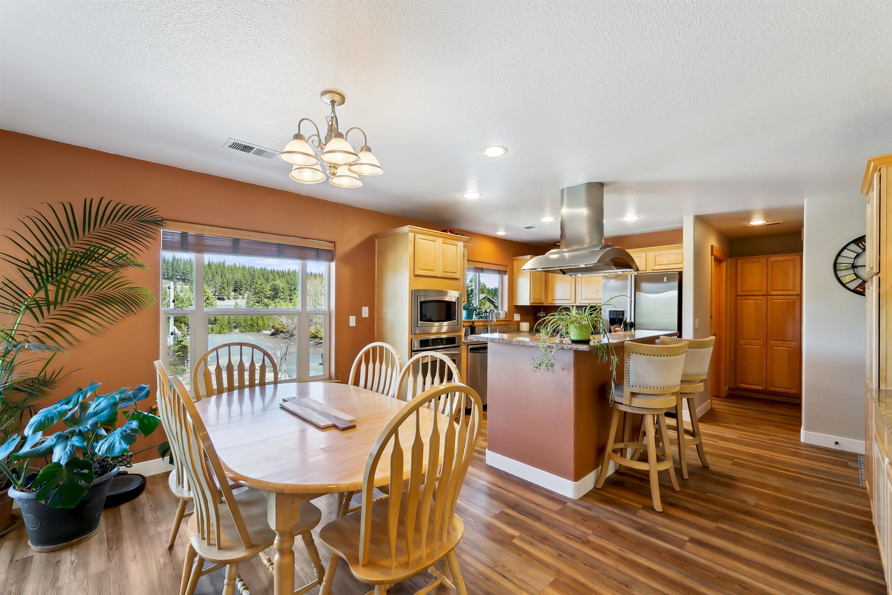 10096 Nicolas Drive, Unit C Truckee, CA 96161 - Photo 6 of 22 a dining room with furniture a chandelier and wooden floor