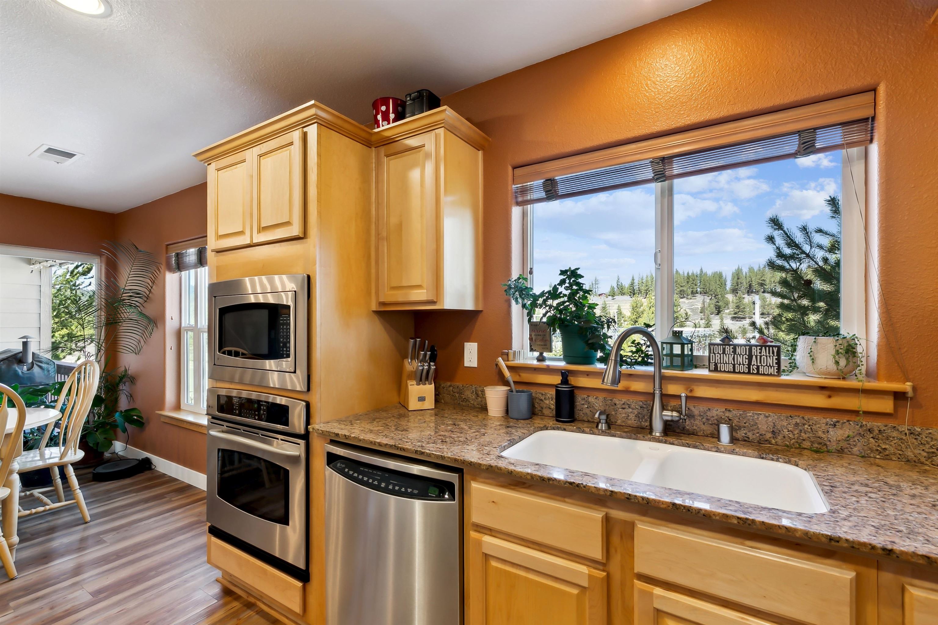 10096 Nicolas Drive, Unit C Truckee, CA 96161 - Photo 9 of 22 a kitchen with stainless steel appliances granite countertop a stove a sink and a microwave