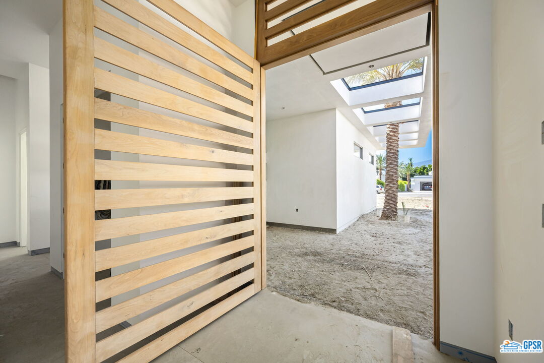 1 Makena Lane Rancho Mirage, CA 92270 - Photo 14 of 22 a view of a bedroom with wooden floor and windows