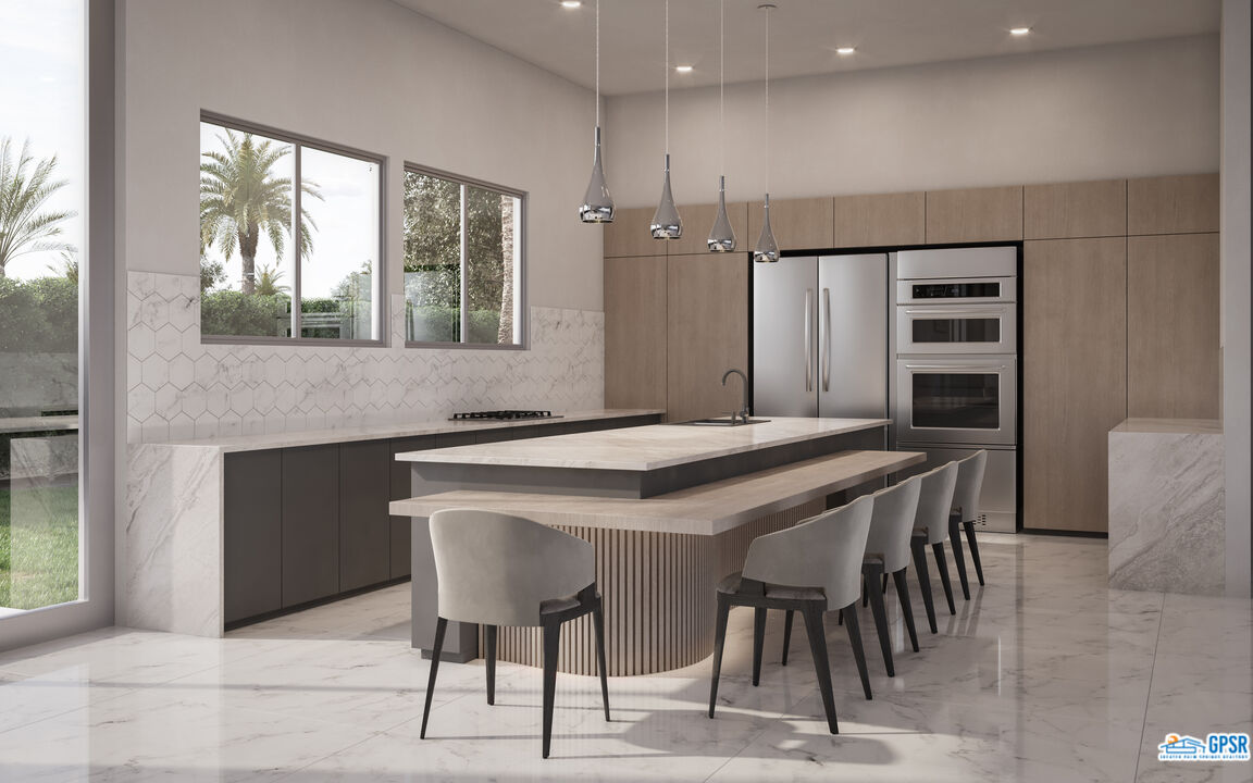 1 Makena Lane Rancho Mirage, CA 92270 - Photo 3 of 22 a kitchen with a table chairs sink and cabinets