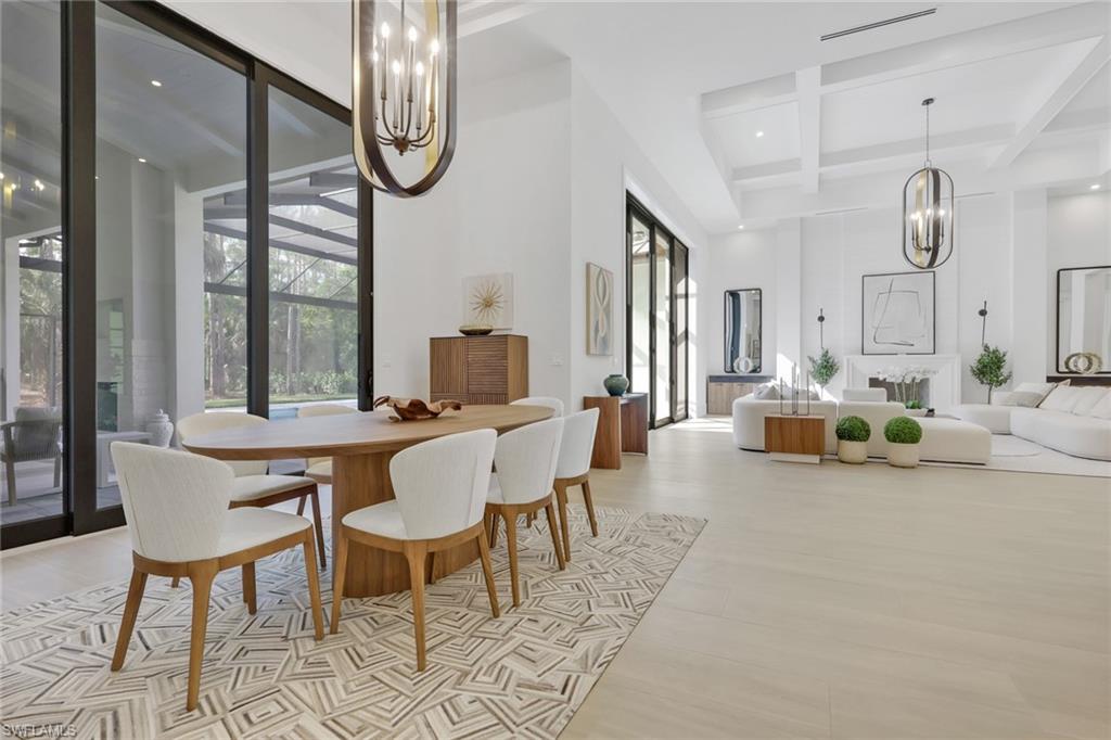 5174 Sycamore Drive Naples, FL 34119 - Photo 11 of 50 a living room with furniture a table and chairs