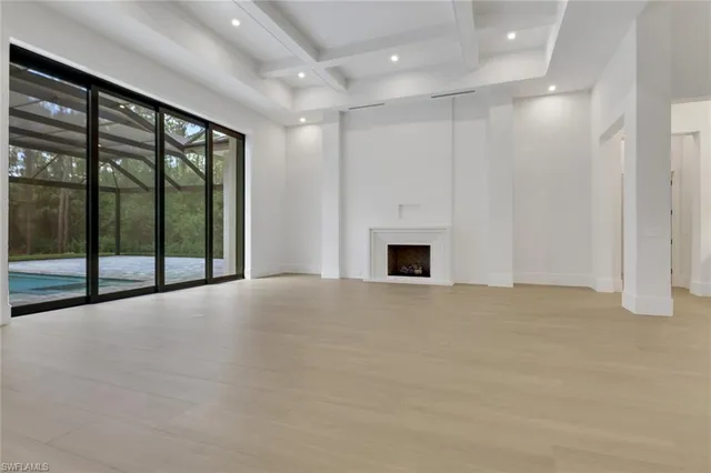 a view of an empty room with a fireplace
