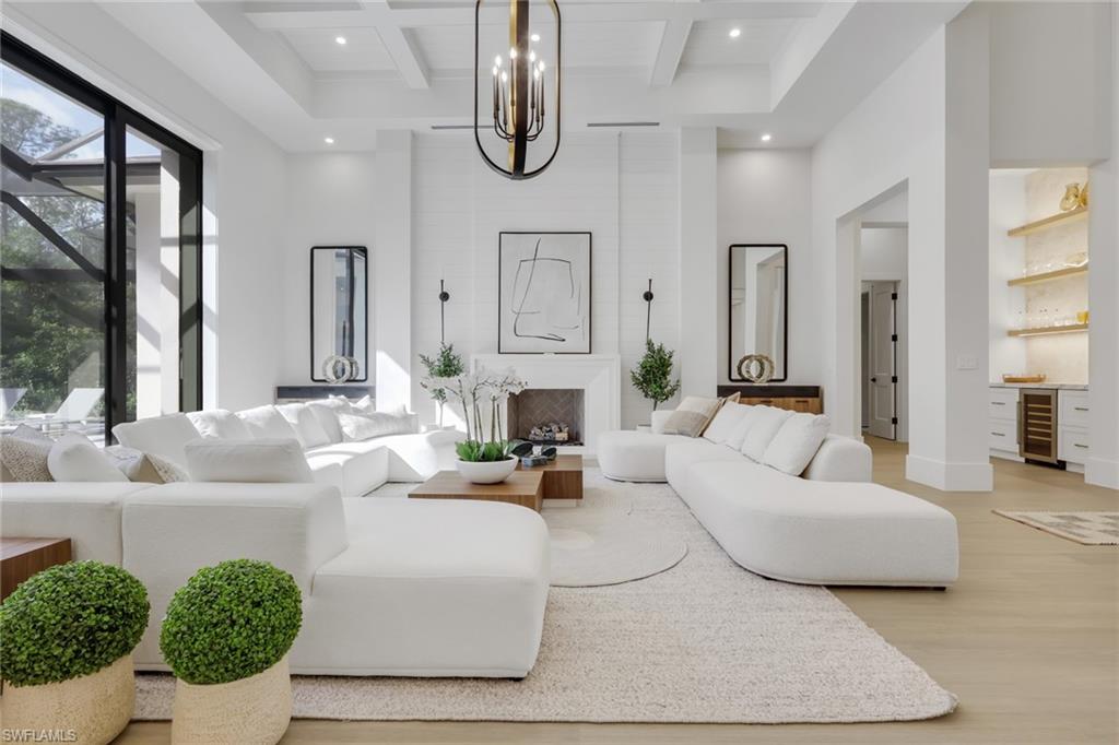 5174 Sycamore Drive Naples, FL 34119 - Photo 12 of 50 a living room with fireplace furniture and a large window