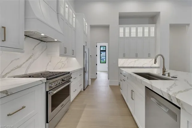 a kitchen with granite countertop a sink stove and cabinets