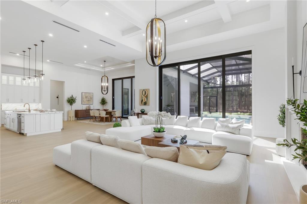 5174 Sycamore Drive Naples, FL 34119 - Photo 15 of 50 a living room with furniture ceiling fan and a large window