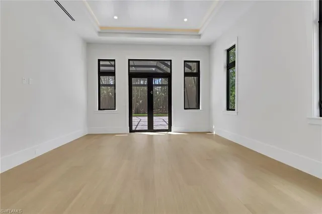 an empty room with windows and closet