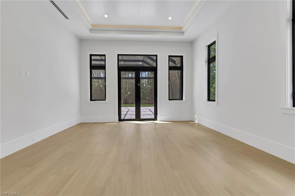 5174 Sycamore Drive Naples, FL 34119 - Photo 17 of 39 an empty room with windows and closet