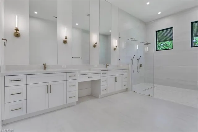 a spacious bathroom with double sink and a large mirror