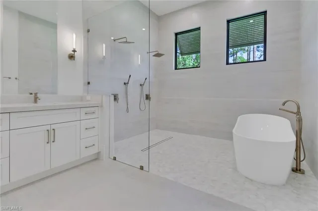 a spacious bathroom with 2 sink toilet and shower