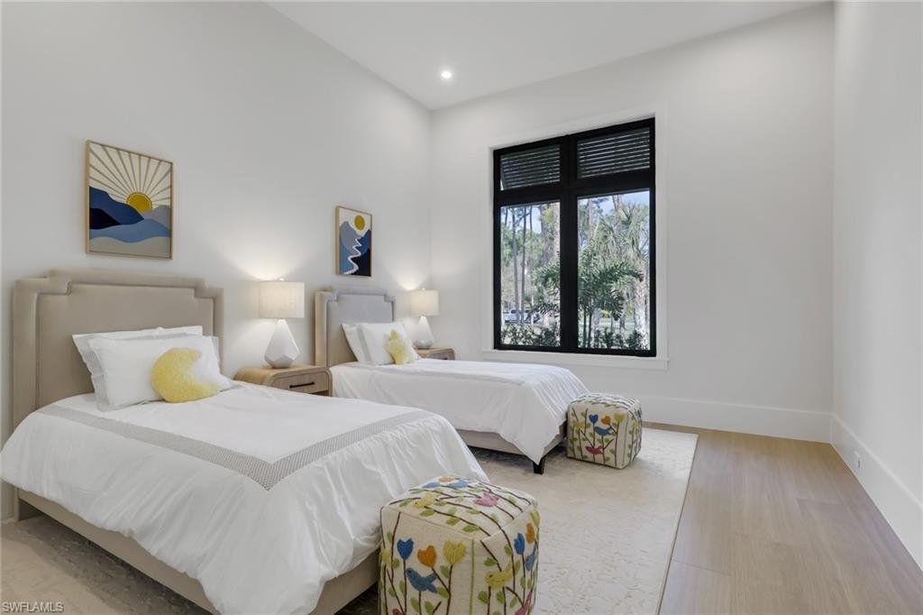 5174 Sycamore Drive Naples, FL 34119 - Photo 28 of 50 a bedroom with two beds and a window
