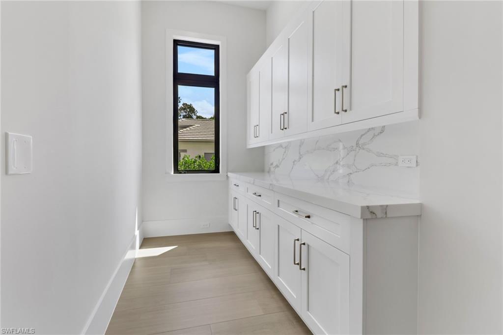 5174 Sycamore Drive Naples, FL 34119 - Photo 30 of 39 an empty room with windows