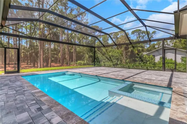 a view of a backyard with a swimming pool