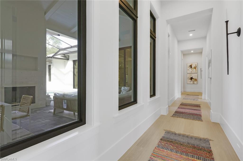 5174 Sycamore Drive Naples, FL 34119 - Photo 37 of 50 a hallway with a view of living room