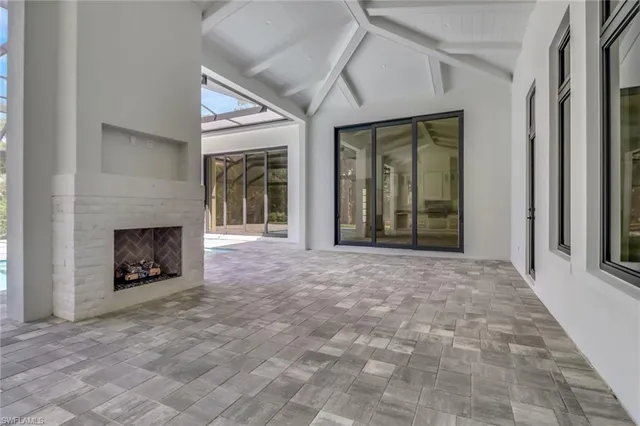 a view of an empty room with window and fire place