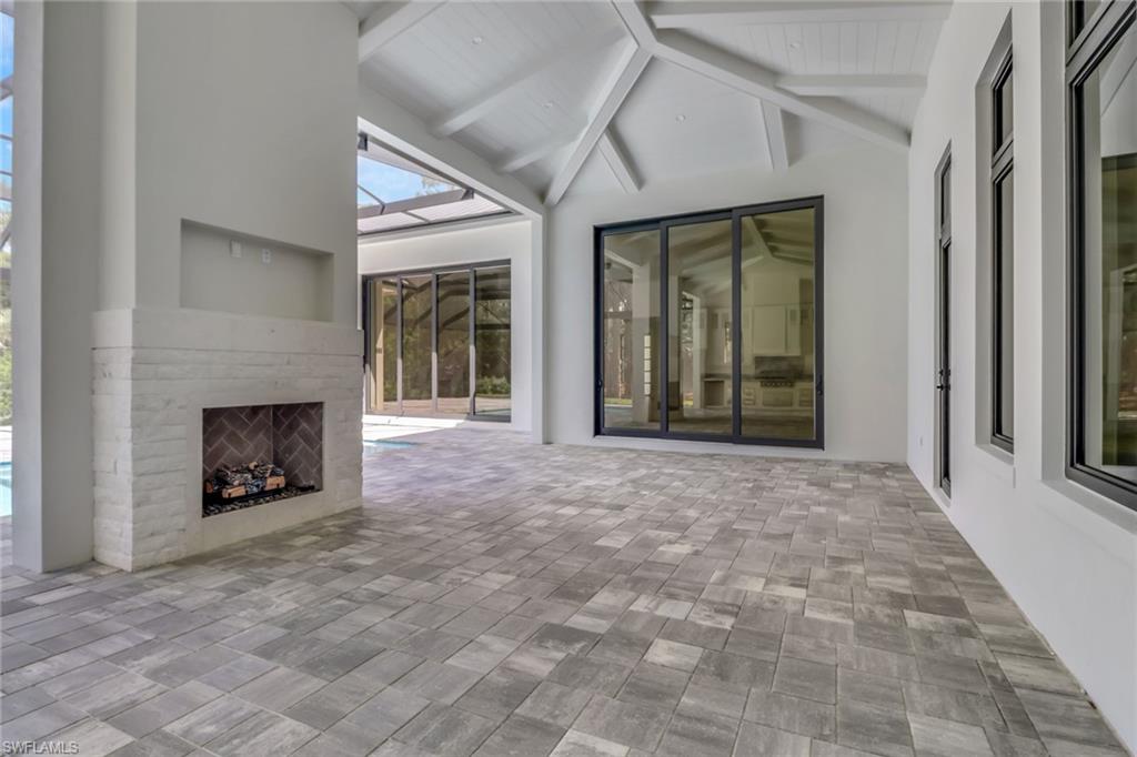 5174 Sycamore Drive Naples, FL 34119 - Photo 37 of 39 a view of an empty room with window and fire place