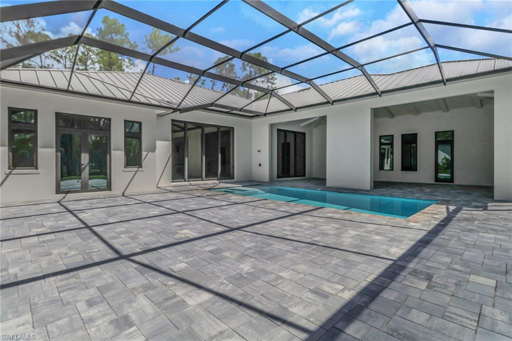 5174 Sycamore Drive Naples, FL 34119 - Photo 39 of 39 a view of a brick house with large windows