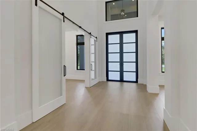 a view of a big room with wooden floor and windows