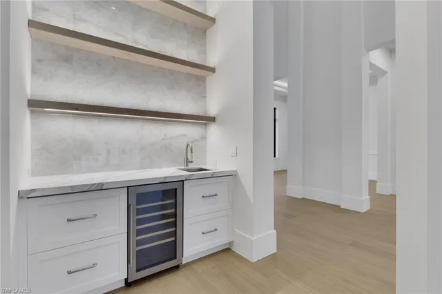 a kitchen with a sink and a refrigerator