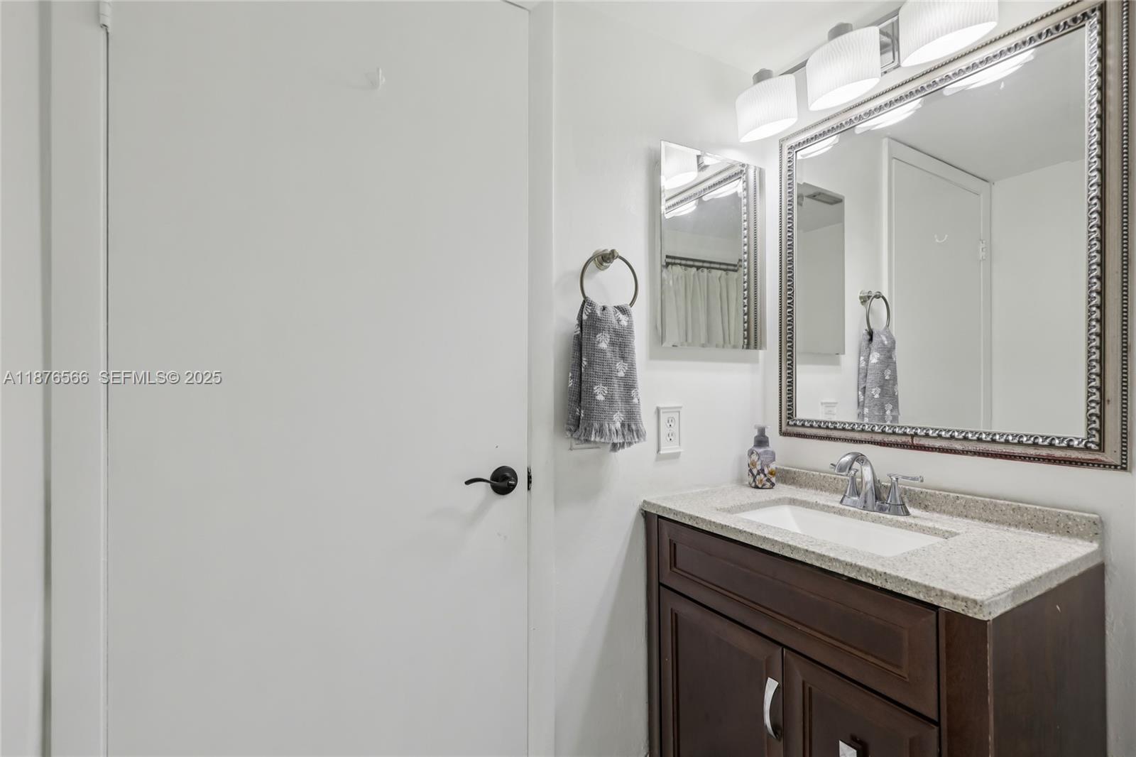 751 Southwest 120th Way Davie, FL 33325 - Photo 18 of 43 a bathroom with a sink and a mirror