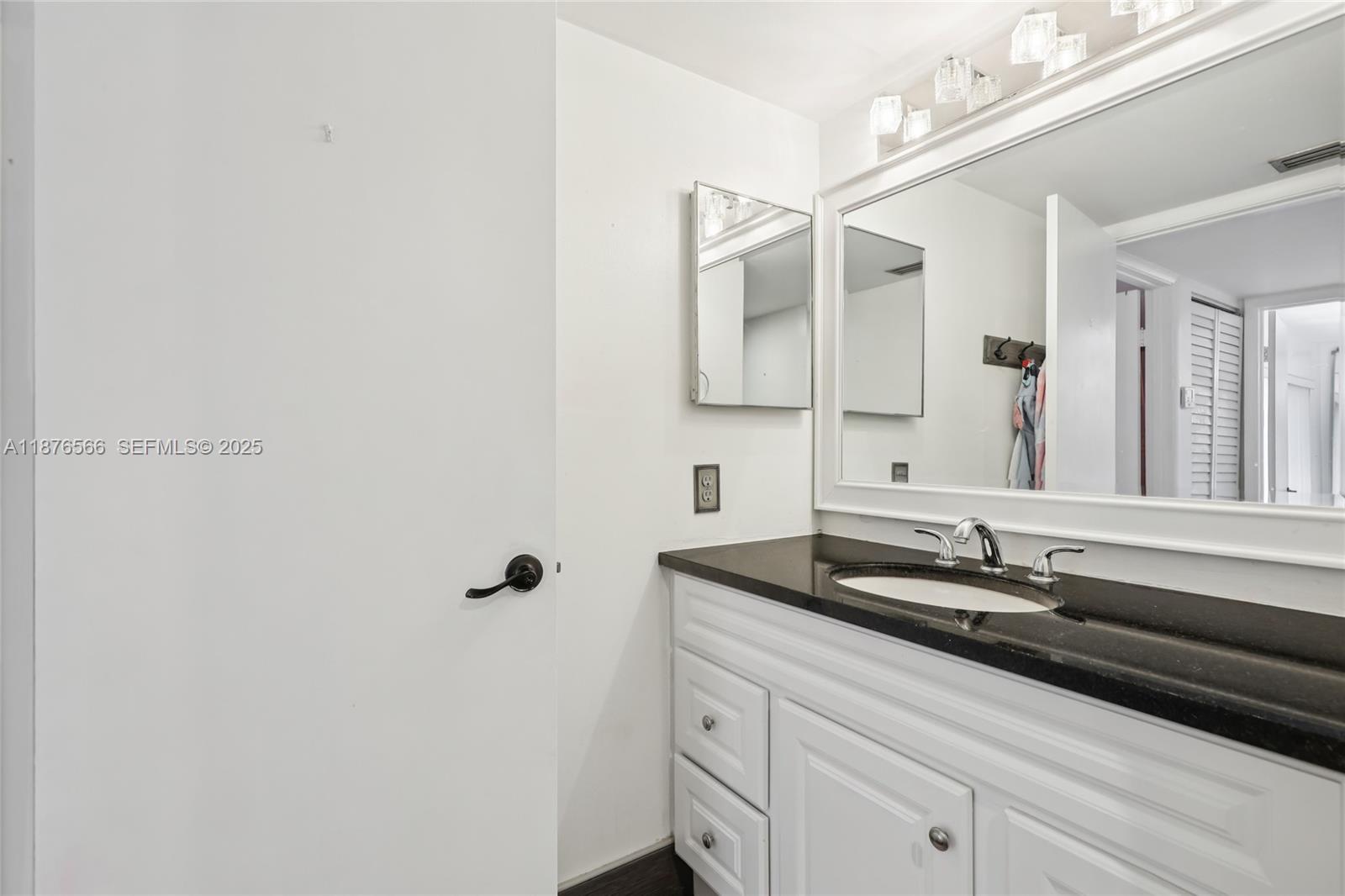 751 Southwest 120th Way Davie, FL 33325 - Photo 20 of 43 a bathroom with a sink and a mirror with window