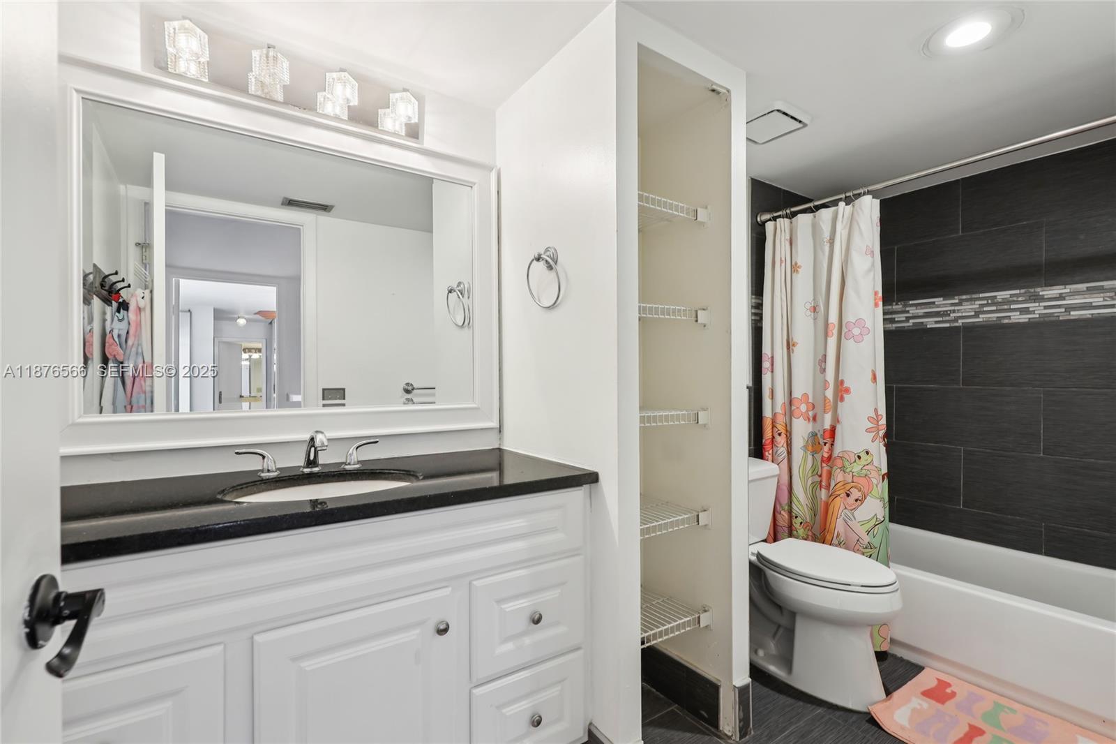 751 Southwest 120th Way Davie, FL 33325 - Photo 22 of 43 a bathroom with a sink a toilet a mirror and shower