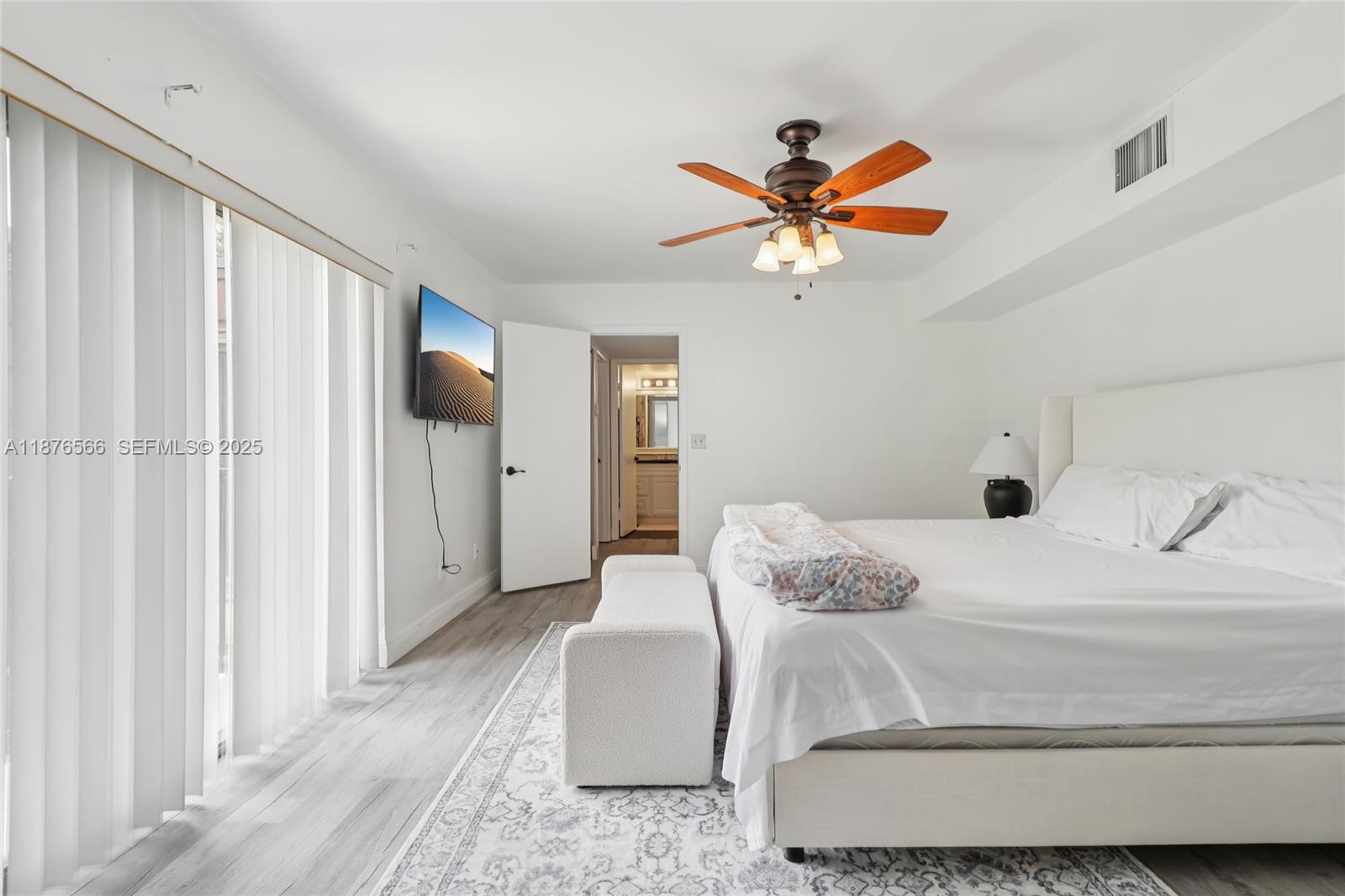 751 Southwest 120th Way Davie, FL 33325 - Photo 28 of 43 a bedroom with a bed and a chandelier