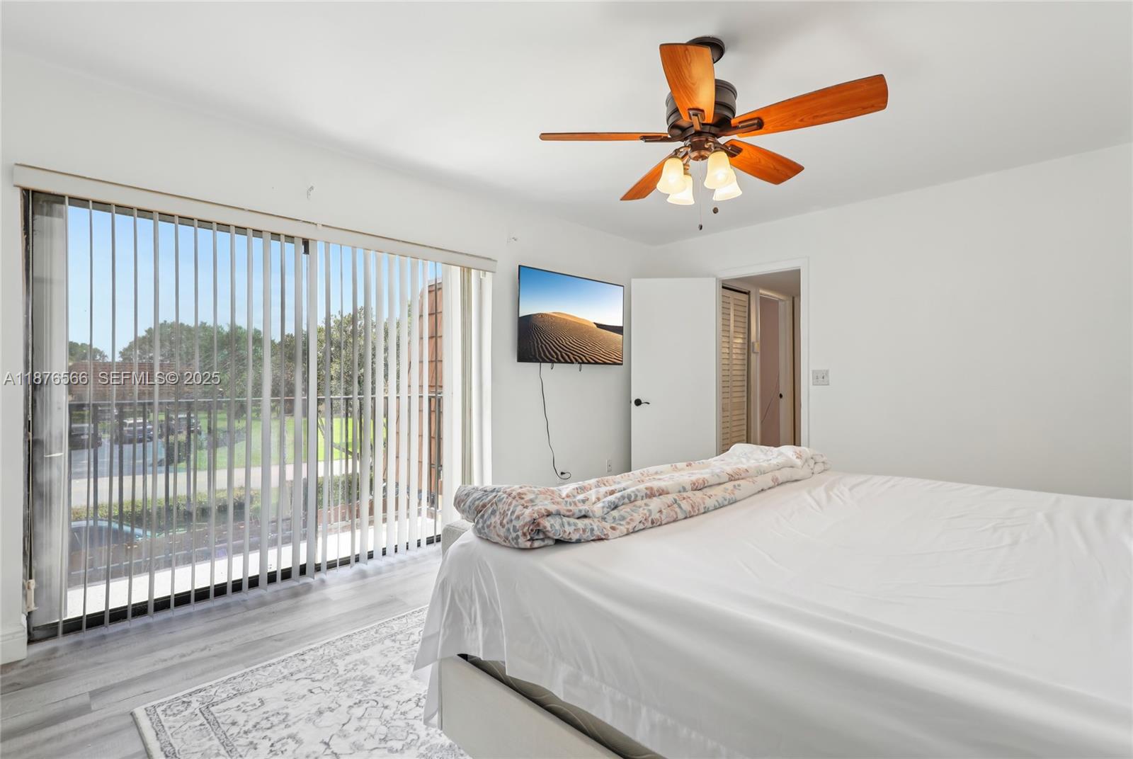 751 Southwest 120th Way Davie, FL 33325 - Photo 29 of 43 a bedroom with a bed and a chandelier