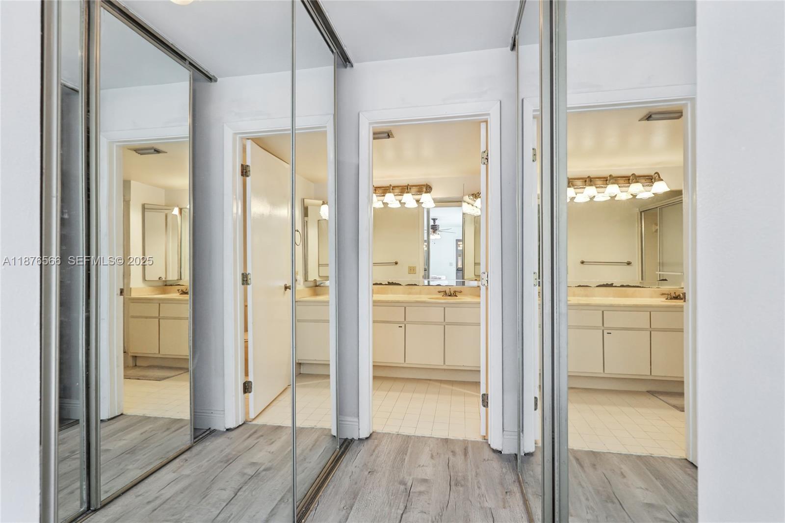 751 Southwest 120th Way Davie, FL 33325 - Photo 31 of 43 a bathroom with a glass shower door and a mirror