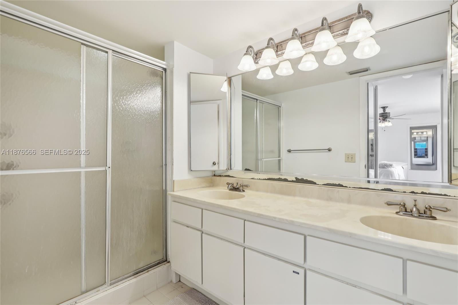751 Southwest 120th Way Davie, FL 33325 - Photo 32 of 43 a bathroom with a sink double vanity granite and a mirror