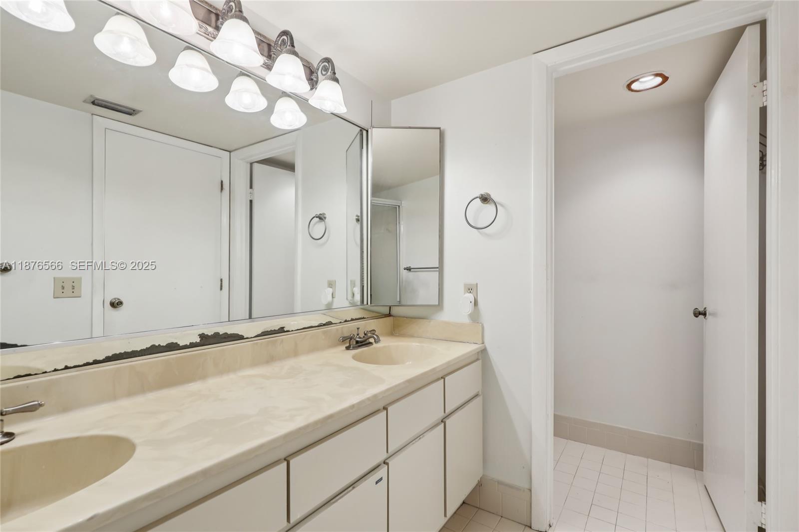 751 Southwest 120th Way Davie, FL 33325 - Photo 35 of 43 a bathroom with a sink and a mirror