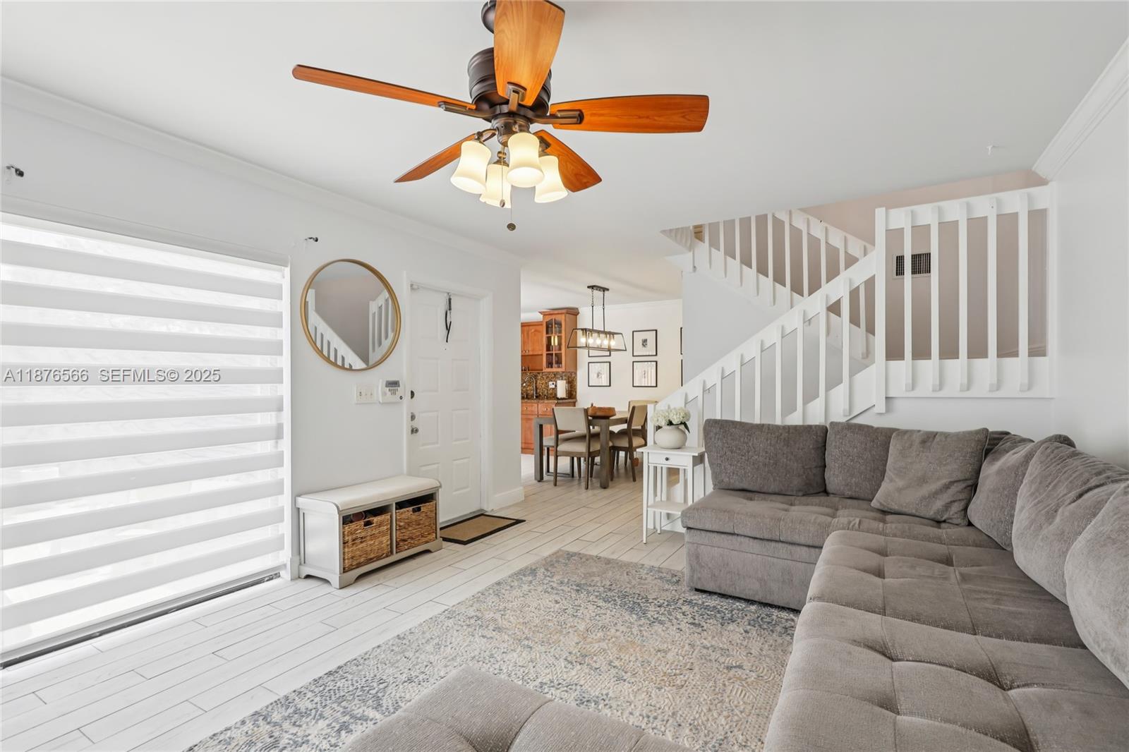751 Southwest 120th Way Davie, FL 33325 - Photo 4 of 43 a living room with furniture a ceiling fan and a rug