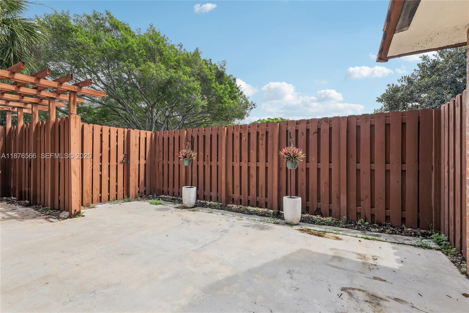 751 Southwest 120th Way Davie, FL 33325 - Photo 41 of 43 a view of wooden fence under a large tree