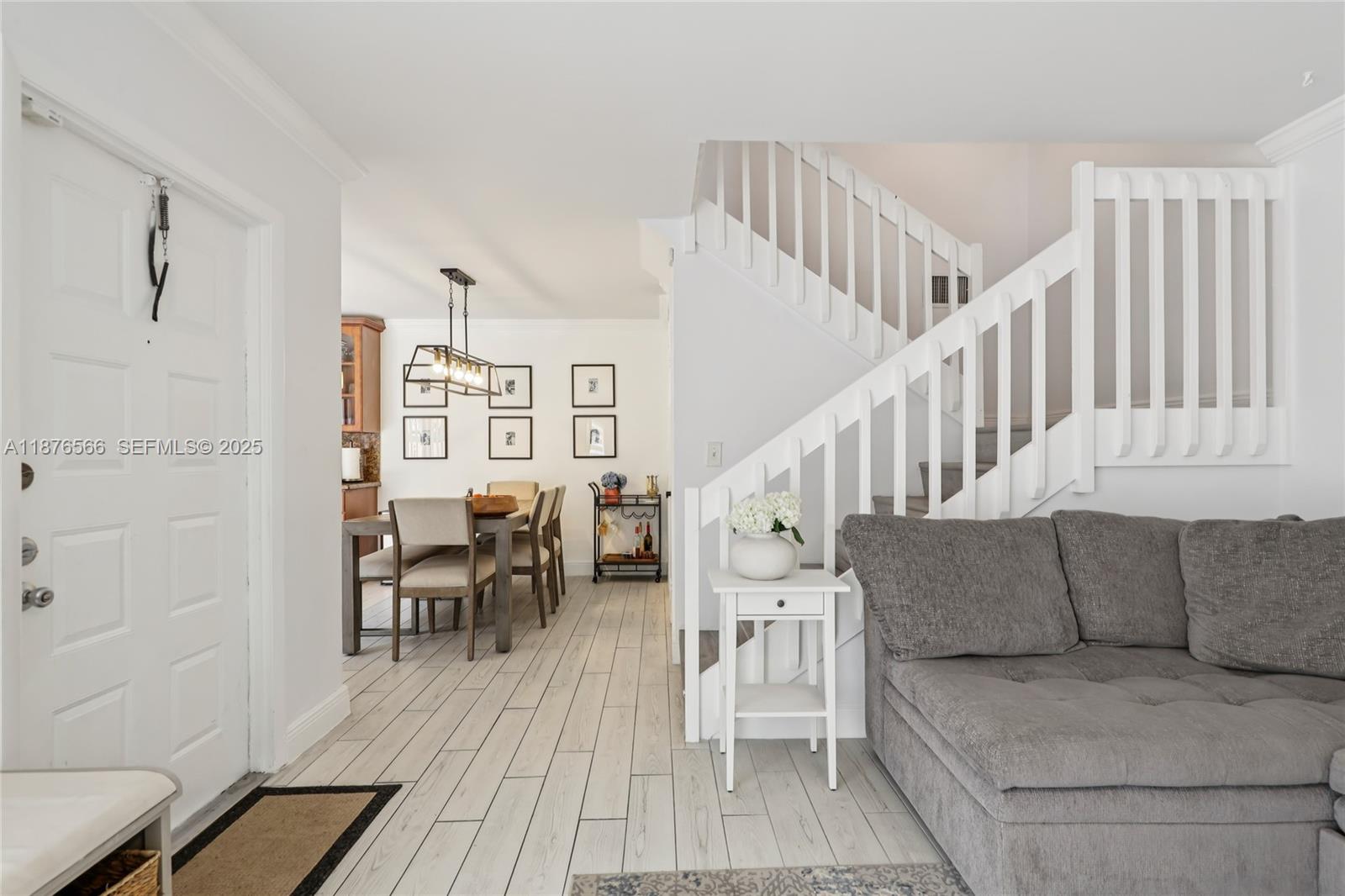 751 Southwest 120th Way Davie, FL 33325 - Photo 5 of 43 a living room with furniture and a dining table with wooden floor