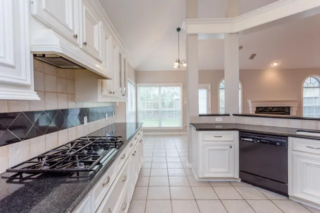a kitchen with a sink and a stove top oven