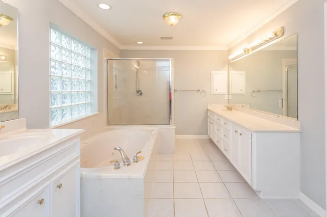 a bathroom with a tub sink and mirror