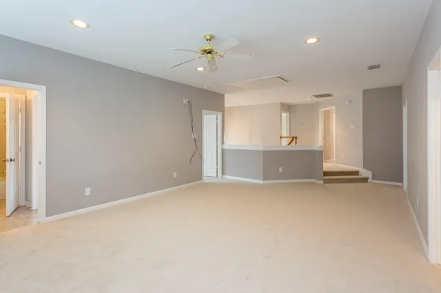 an empty room with a empty space and a ceiling fan