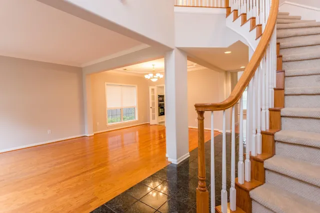 a view of an entryway with wooden floor and door