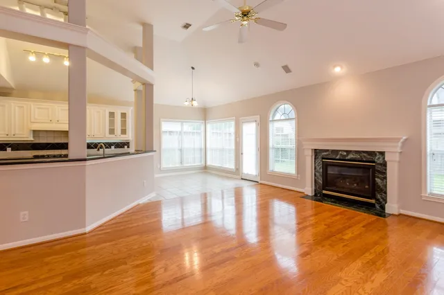 a view of an empty room with a fireplace and a window