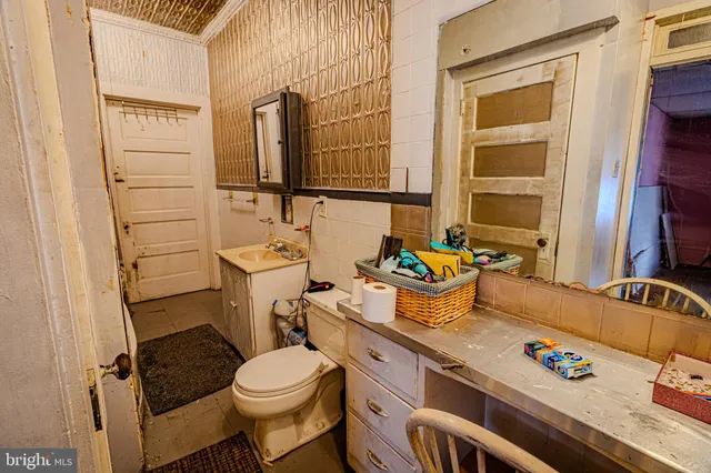 a view of a kitchen with fridge and window