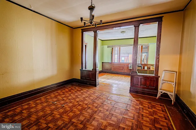 a view of an empty room with a window and a ceiling fan