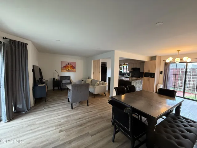 a living room with furniture a table and wooden floor