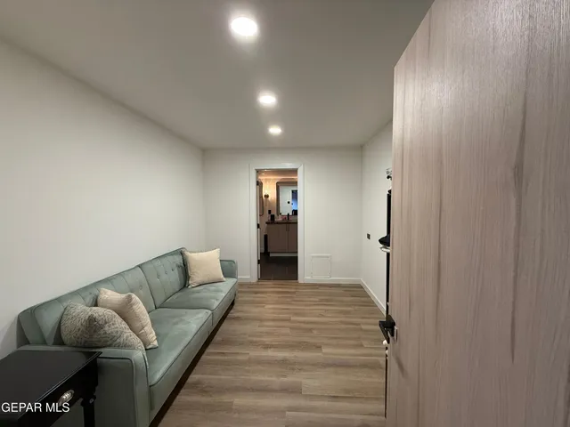 a living room with furniture and wooden floor