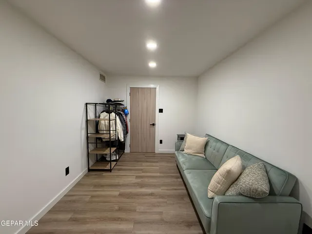 a living room with furniture and a walk in closet