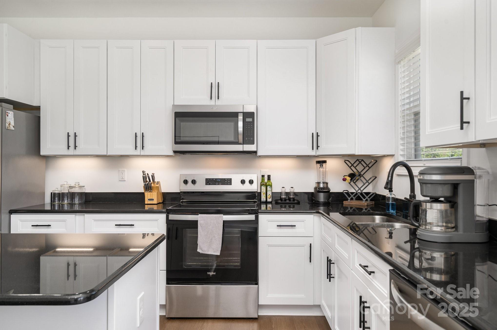 125 St Peters Church Road Gold Hill, NC 28071 - Photo 14 of 33 a kitchen with stainless steel appliances granite countertop a sink stove and microwave