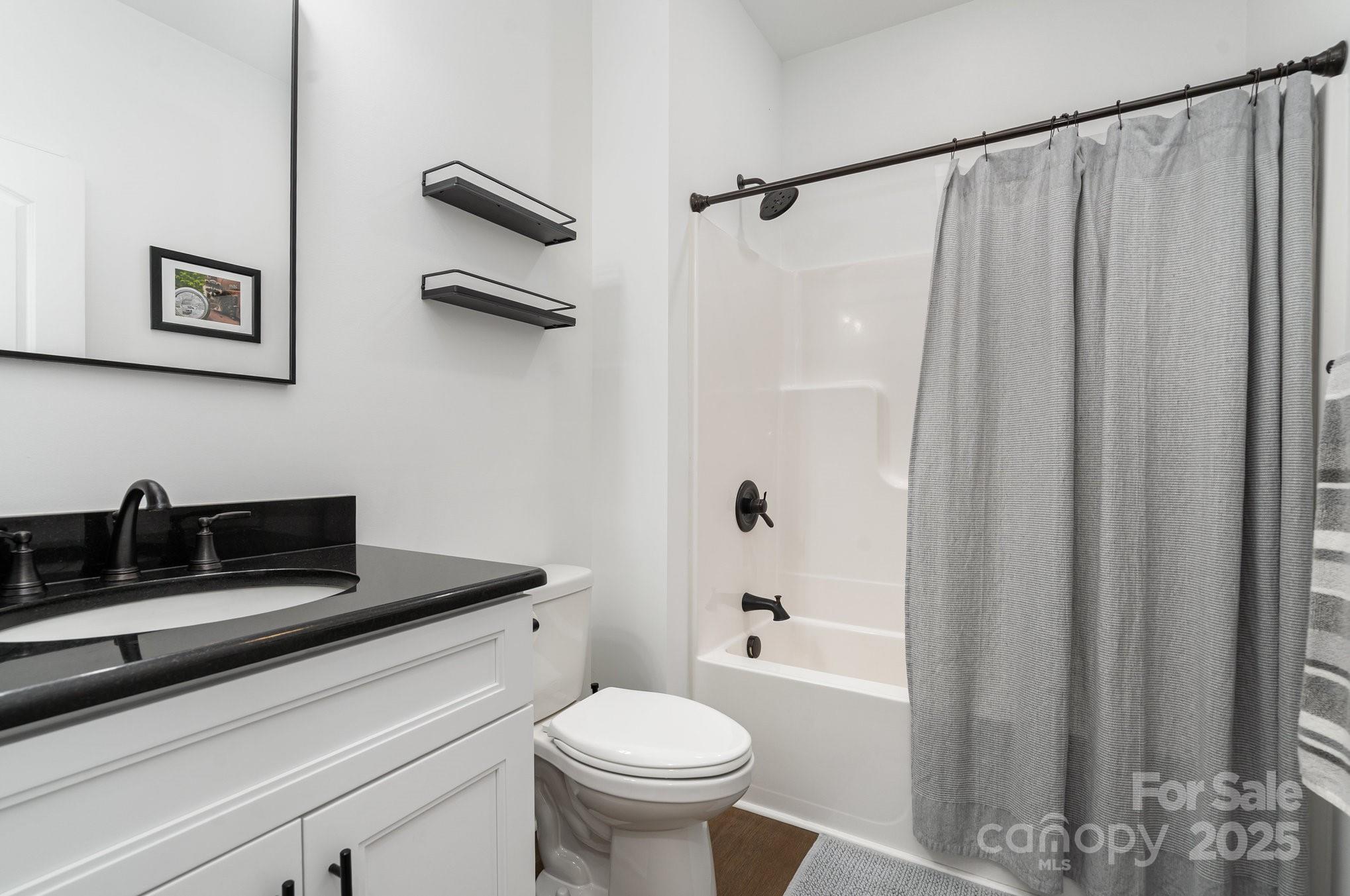 125 St Peters Church Road Gold Hill, NC 28071 - Photo 26 of 33 a bathroom with a sink a toilet and a shower curtain